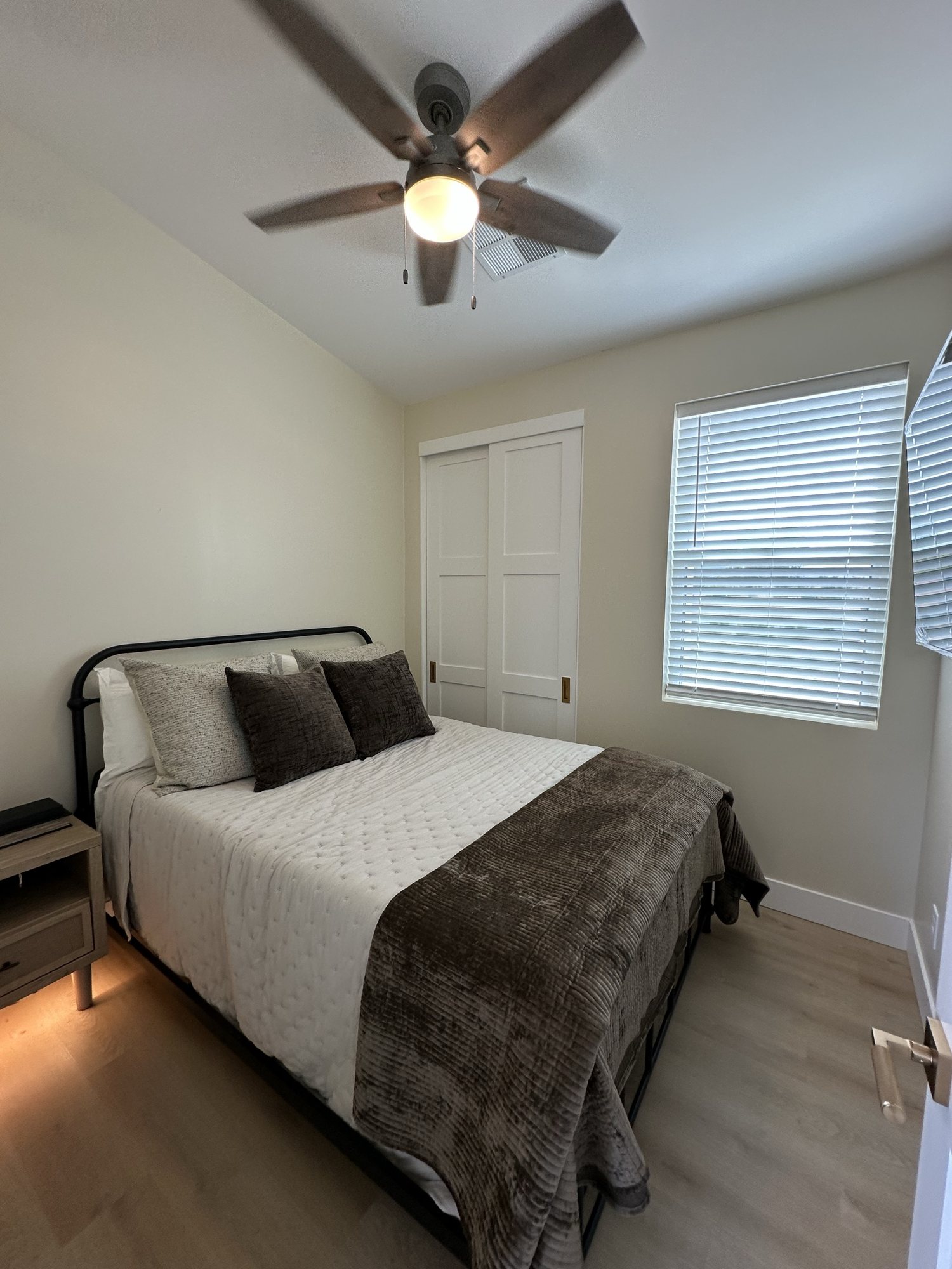 Furnished bedroom with ceiling fan