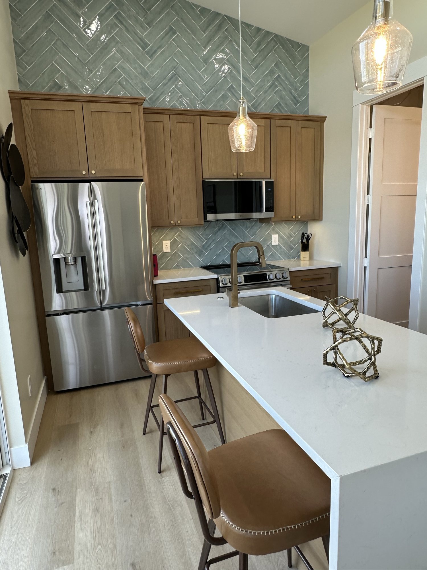 Kitchen with stainless steel appliances and quartz island seating