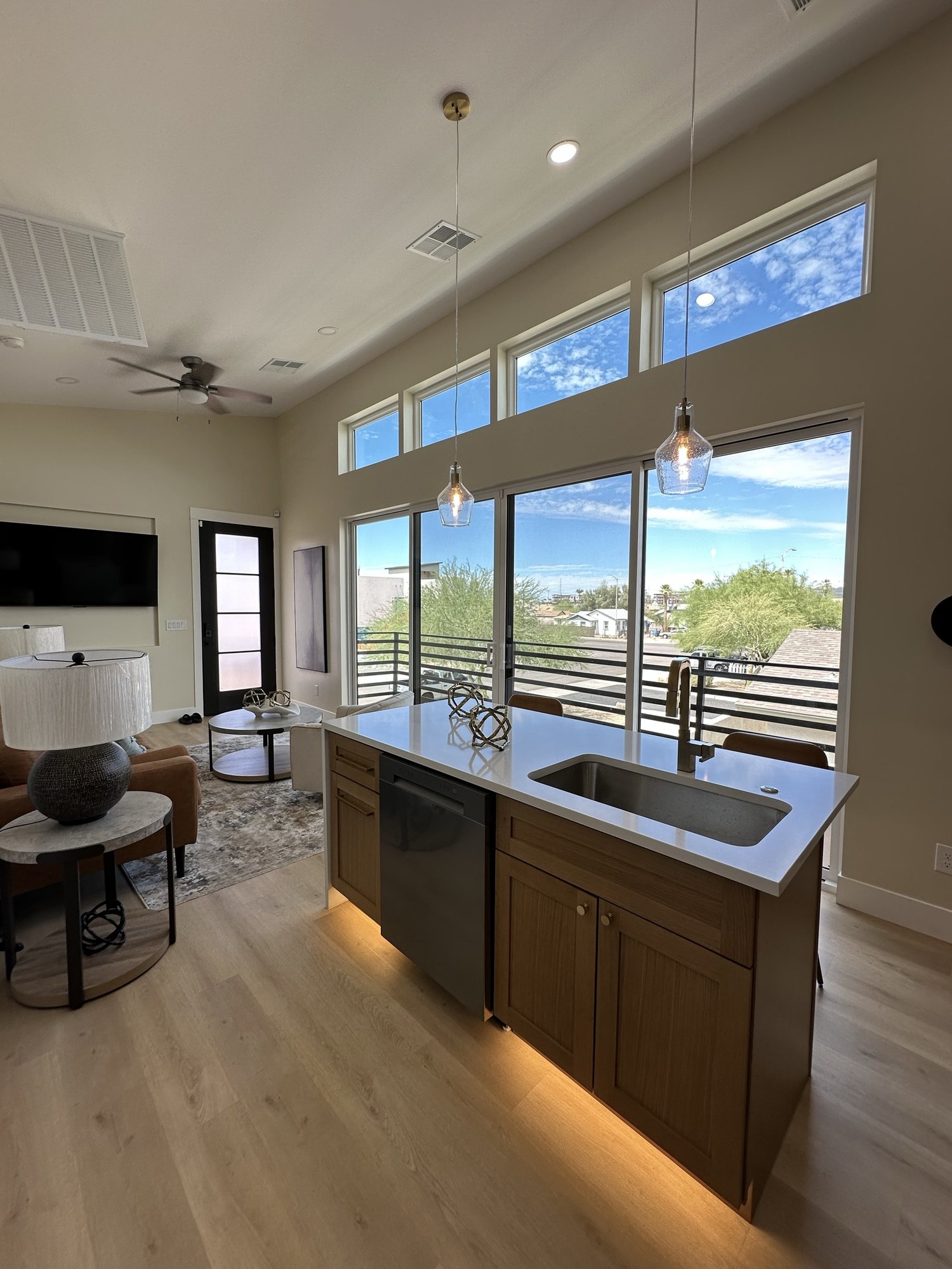 Quartz kitchen island with undermount sink and accent lighting
