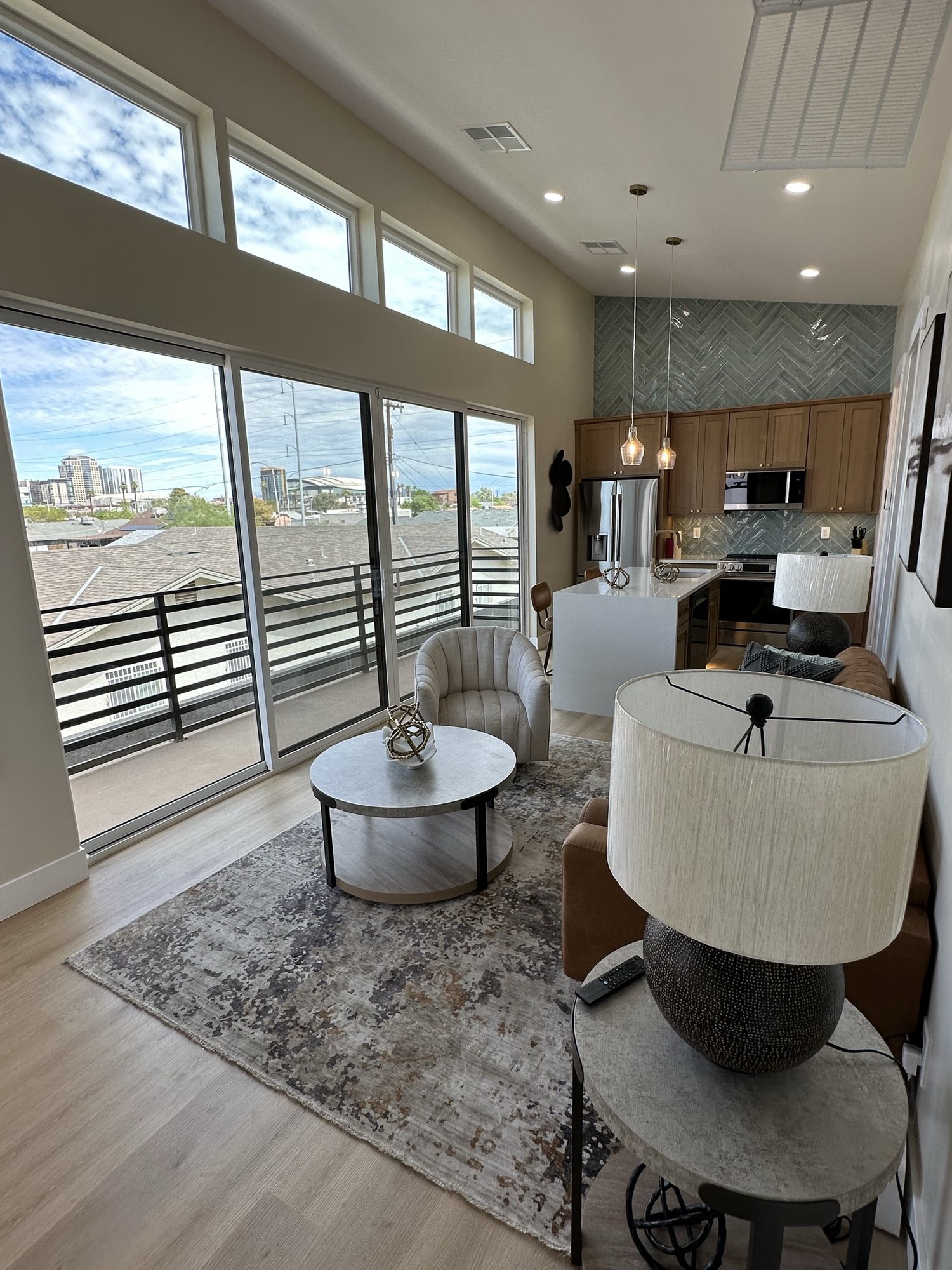 Living room with clerestory windows and sliding doors to the balcony